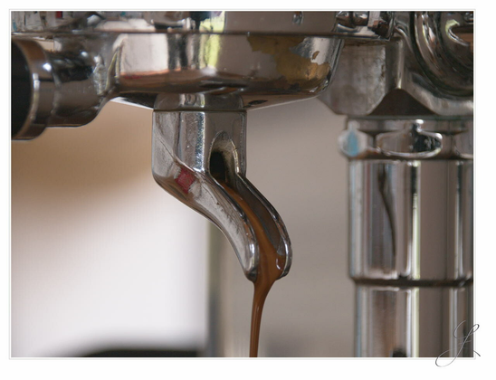 The quadratic crop shows a closeup of the portafilter of a Faema E61 group from which dark brown espresso coffee is just pouring out. To the left and right the unsharp chromium surface of the group can be seen. The view angle towards this "coffeefall" is about 45° left from the straight view. The background is unsharp.

AI disclaimer: Using my work, its meta data, written or derived description to create media with or train AI based systems is prohibited.