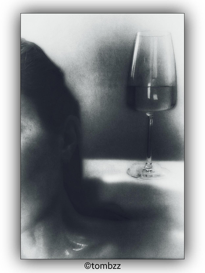 A photograph showing a woman in a bathtub. Only a portion of her head and face is visible, along with her neck and collarbone. A wine glass is also present in the scene, adding a touch of elegance. The background has a distinct texture, enhancing the overall subtle and intimate atmosphere of the image.