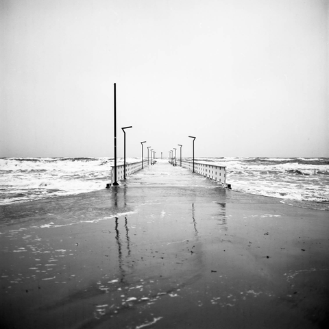 Black and white photo showing stormy weather at sea.