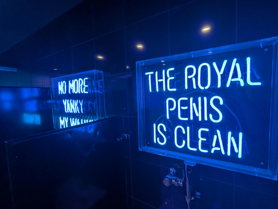 Neon signs at the urinal which read "no more yanky my wanky" and "the royal penis is clean"
