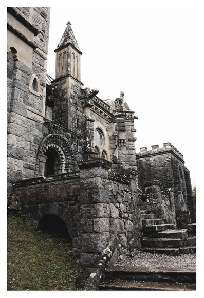 Colour portrait photograph of an ornately carved granite church.
