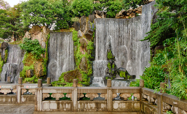 Garden with artificial waterfall on the temple premises.