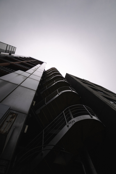 photo of the staircase at the outside of a building in Tokyo, photographed steep from below, leading to a kinda scary looking perspective