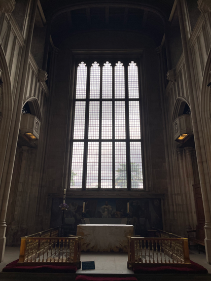 A giant glass window at the one end of the church 