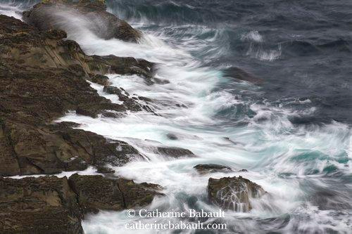 Big waves crashing on a rugged coastline.