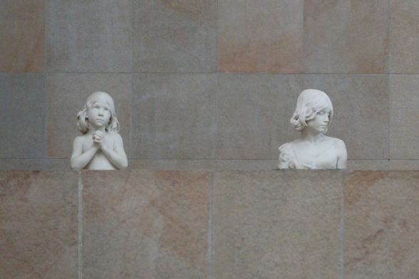 Upper part of two sculptures of children