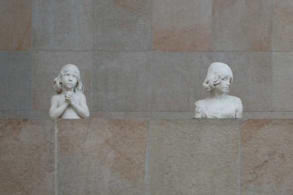 Upper part of two sculptures of children