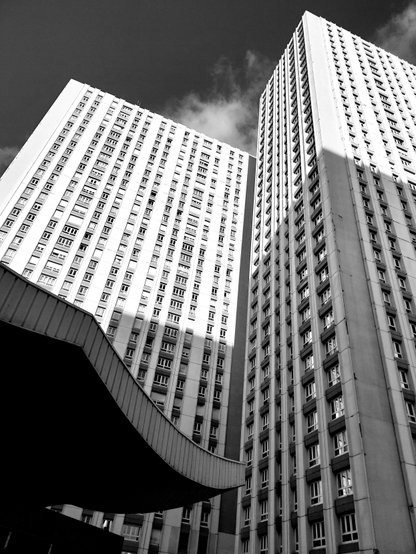 Building brutaliste dans le 13ème arrondissement de Paris, quartier asiatique. Une aile de pagode au bas de la photo monchrome en contre-plongée sur l'immeuble.