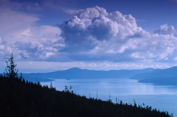 Massive clouds form over the gulf islands, looking east of Vancouver Island, in British Columbia Canada circa 1994