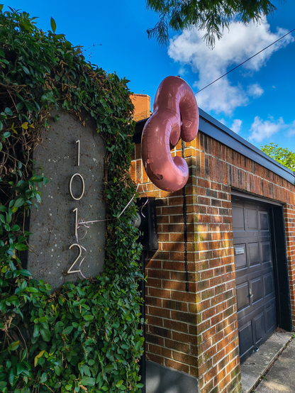 Birthday party welcome sign, an inflatable letter E. 