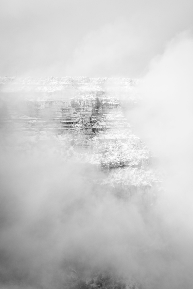 The South Rim near Maricopa Point peeking out of the fog during a snowstorm.