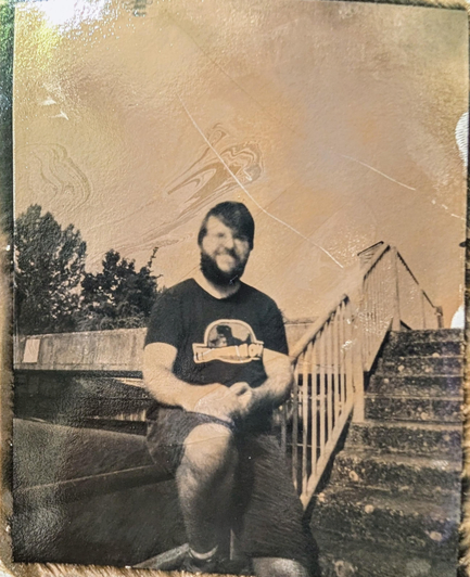 A black and white photo of myself, taken with a pinhole camera on direct positive paper 