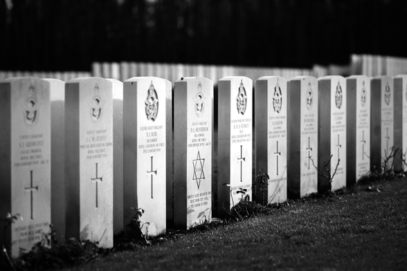 Gravestones on a WW2 military graveyard of the Commonwealth. Most stones have crosses carved into them, but one has a Star of David.