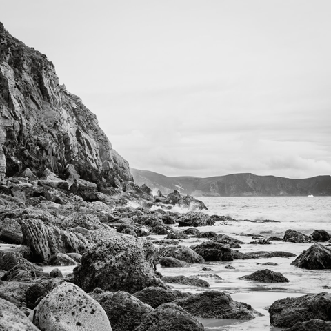 waves crashing agains rocks along a shore