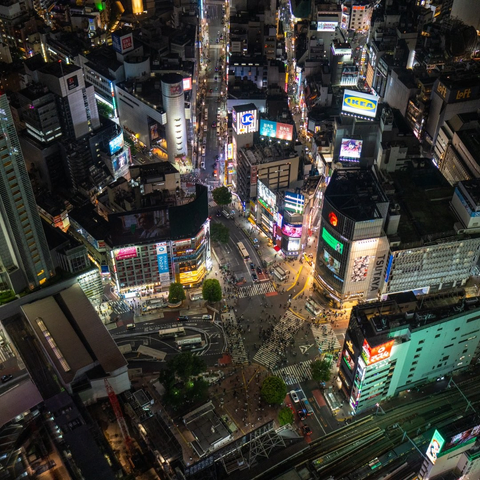 People navigating the Shibuya Scramble Crossing in Tokyo, as seen from the observation level of Shibuya Sky.