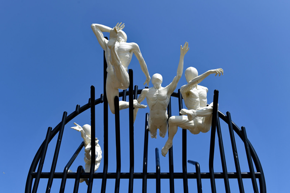Photo of  four life-size bronze figures and steel grid. Installed on the Hove Plinth on 17 September 2023. City of Brighton & Hove, UK.