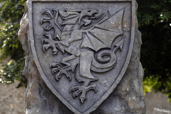 A stone shield with a Welsh Dragon carved into it. 
