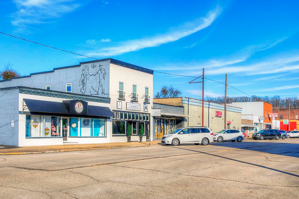 Yoakum Street Chaffee Missouri 

A quaint small-town street features several storefronts, including a cafe and bakery, under a bright blue sky. 