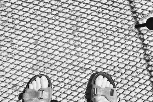 No slip flooring made from thin metal lattice. My feet for scale.