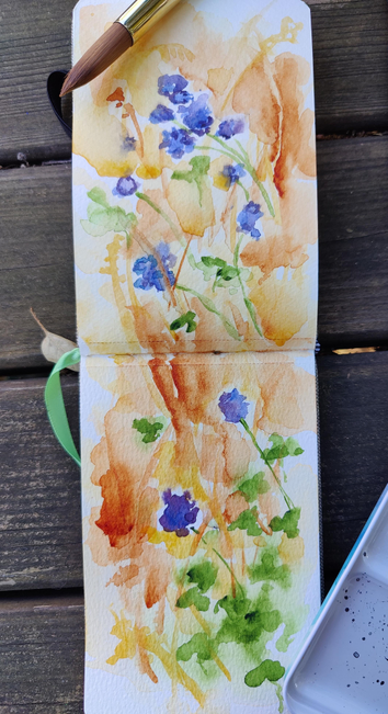 A rectangular sketchbook with a quick, loose wildflower watercolor in dry grasses. Purple flowers, golden dry grass, some green with oak tree saplings.