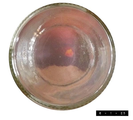 June 2016 sunset photo as seen through the bottom of a clean, clear glass jelly jar 