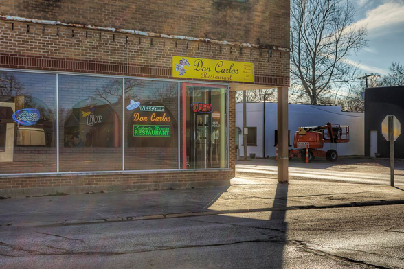 Sunlight Blasting Through a Street Corner

A restaurant with a yellow sign and large windows is situated on a street corner, reflecting a sunny day.