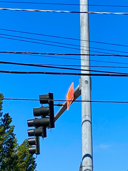 a road name sign seen from three-quarter view with all the white parts glowing like hot molten lava 