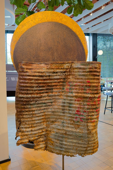 A piece of art that looks like a giant rusty food can.