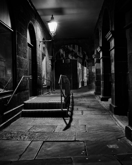 Looking along Victoria Terrace at night to a single lamp