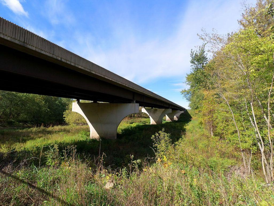 Photo of Interstate 90 as it passes near Blue Earth, Minnesota, as viewed from the bike trail that crosses below it.