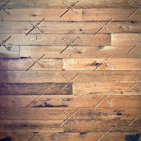 The Portland International Airport classic blocky airstrip design takes on a windmill form with miniature Dutch Bros logos inside it, as it tiles out in a stamped, recessed pattern across a wall of wooden planks.