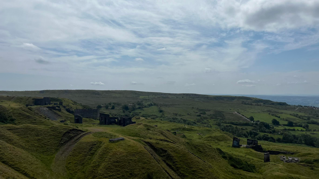 The view from higher up on Titterstone Clee, showing multiple abandoned quarry buildings.