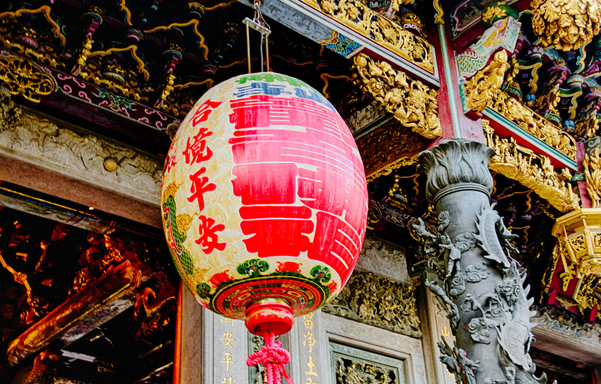 A large lantern in front of the temple entrance.