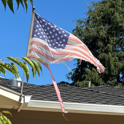 A faded, shredded, USA flag