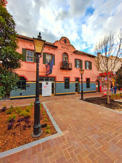 The Old Fitzroy Hotel, which is looking for a new owner. A charming salmon–coloured building with grey shutters.