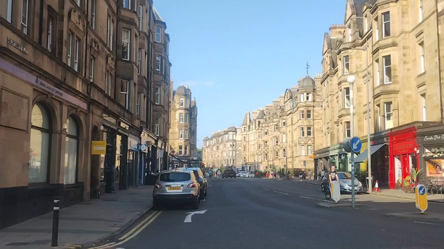 Panning 180 degrees around Bruntsfield Place on a hit, bright, summer evening, old stone tenements bathed in sunlight, every cafe, bar & restaurant with outdoor areas busy with people enjoying the hot weather