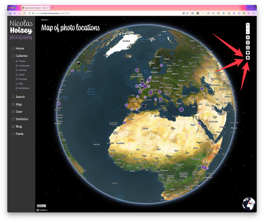 Screenshot of the “map” page of my photography site, with the Earth rendered as a globe with satellite imagery, control buttons on the top right, and 3 big red arrows pointing the “play” button
