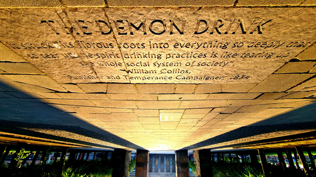 A quote inscribed into the flagstones of Glasgow Green. It reads: The demon drink. It stretches its fibrous roots into everything so deeply that to tear up the spirit drinking practices is like tearing up thr whole social system of society. William Collins. Publisher and temperance campaigner, 1834.