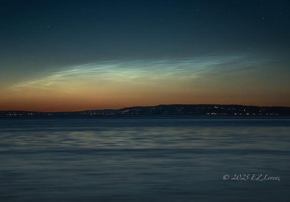 The NLC season has started in Washington state! 
I have a fascination with these rare, very high-altitude noctilucent or night shining clouds (NLC) hanging at the edge of space with an electric blue glow, can’t be mistaken when these beautiful luminous blue-white tendrils are spreading across the sky in sunset afterglow over the Salish Sea (as seen here). 

They’re composed of very small water ice crystals formed on minute particles of dust, possibly of cosmic origin from micrometeors. They are visible in the northern hemisphere at latitudes between 45˚and 65˚north, and occur after sunset or before sunrise from mid June to the end of July here at our latitude (47°). 

Edmonds, WA
June 07, 2025 - around 11PM