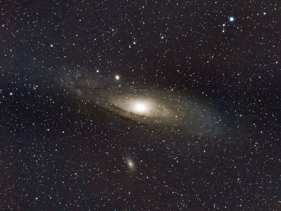 the famous Andromeda galaxy (m31) with also m110 in the shot. Large spiral galaxy with bright bulb and visible stripes of dark gases. Lots of stars in the background (but in fact, in the foreground)