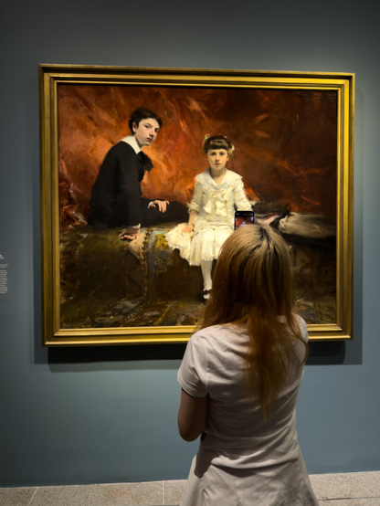 The Pailleron Children, John Singer Sargent. Metropolitan Museum, NYC, June 20, 2025, 8:15pm.

Phone photo, post in LR Mobile.

Went to the Met last night to catch the early American photography exhibit. Then went to the Sargent in Paris show in (practically) the next gallery.

I’m surprised, but the in-box camera app did a very creditable job of capturing the experience, especially with in in-app (proprietary) HDR rendering on the phone (not visible here). I think it’s because of the low light (EV 0 according to the metadata, and that agrees with my metering for film shots) — in dim light that’s still adequate for full color saturation, there is for me a heightening of the experience. Must be that (driven by aesthetics or commerce) the phone app image chain designers have gone for that look by default.

I took this shot because the girl’s expression reminds me of one of @bosak’s shots of a girl sitting for a portrait (acrylic? I have memory of thick paint on a palette but might not be accurate) at a fair.

The painting is also known as Portrait of Edouard and Marie-Louise Pailleron.