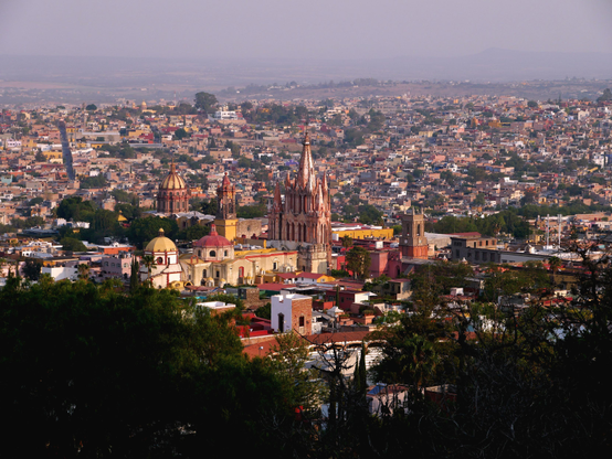 Hilltop view of the city of San Miguel de Allende, Mexico, featuring a large cathedral in the center