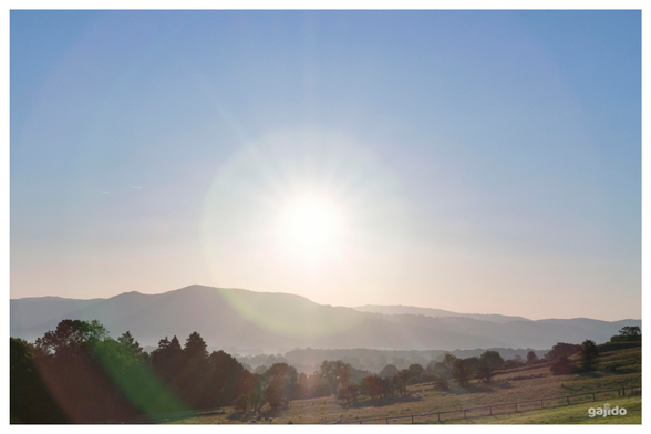 A summer solstice sunrise over Welsh hills.