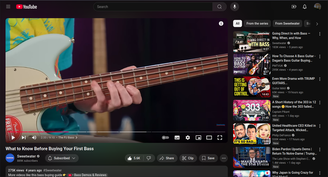 screen cap of vid with a bass guitar displayed showing the neck with the presenter playing