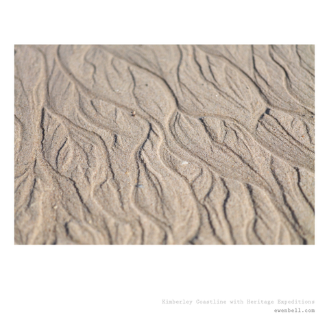 retreating waves leave rivulet patterns on the beach