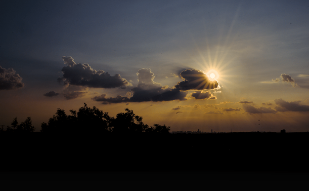 sunset with clouds partially masking, glares et all.