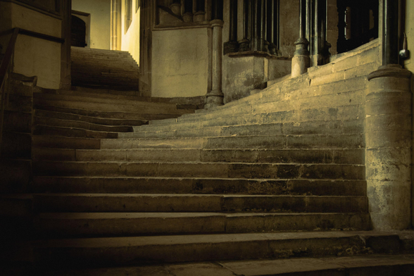 View from below on a majestic set of stairs leading up and to the right (towards the door of the Chapter House).