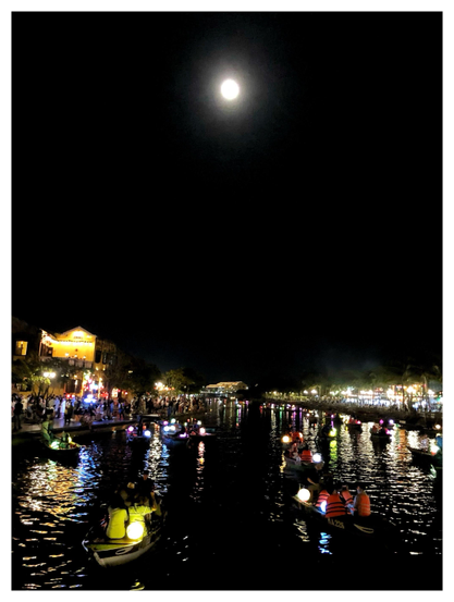 An evening scene at the bustling Night Market in the historic Ancient Town neighborhood of Hội An, Vietnam. A big attraction is the lantern boat rides down the Hoai River, with the crowded market on both sides. This is actually an attempt at a composite as I stitched together two photos of the same scene; I preferred the moon from one shot and the composition of boats in the other. I think it conveys a serene, magical mood, although it fails to capture how loud and packed the scene actually was.

Image description: Nighttime image of a wide river receding into the distance under a glowing full moon in a featureless dark sky. Many small boats float on the river, carrying passengers in life jackets and illuminated spherical lanterns of various colors. On both banks of the river are trees and low buildings lit up against the dark, and crowds of people milling around. The lights of the town and the boat lanterns cast reflections on the rippling waves of the river.