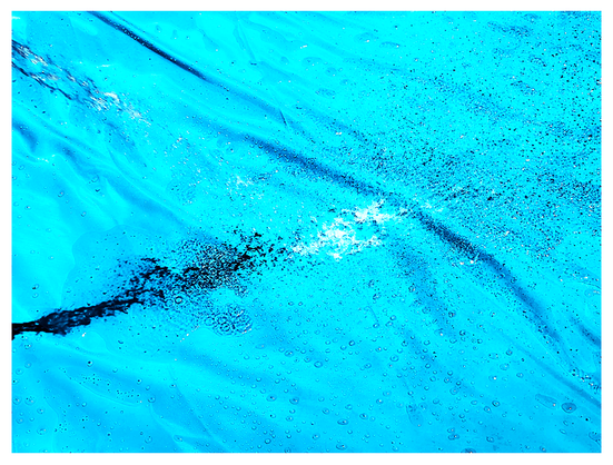backyard pool. abstract. a black hose filling the light blue, vinyl pool causes riplles and distortions in the water and wrinkled bottom.