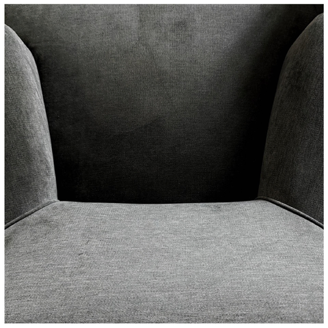 A square photo showing a close-up view of a gray upholstered chair showing the seat cushion and curved armrests.